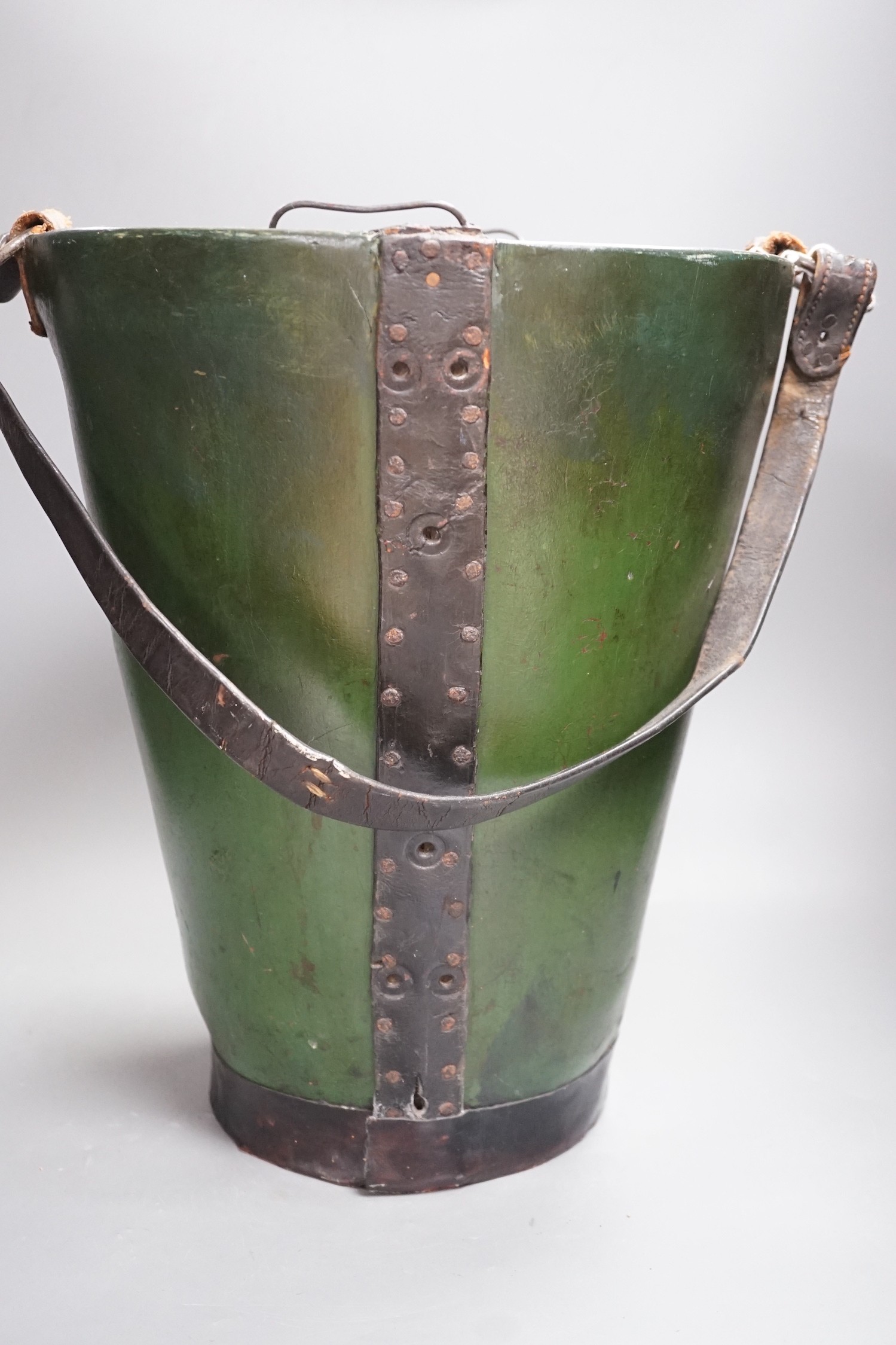 A green painted leather fire bucket with metal liner, 38cm